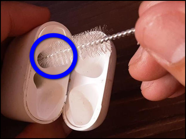 Insert a soft brush in your AirPod’s case to clean the port